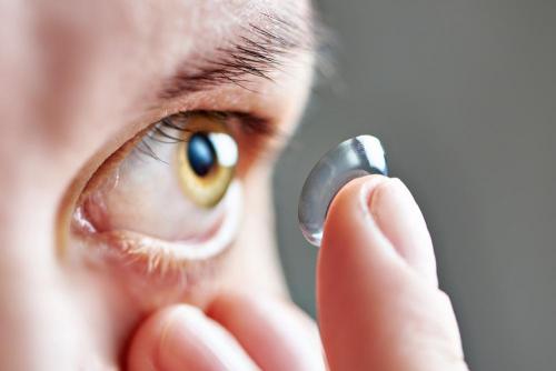 Patient at University Eye Associates putting on contact lenses